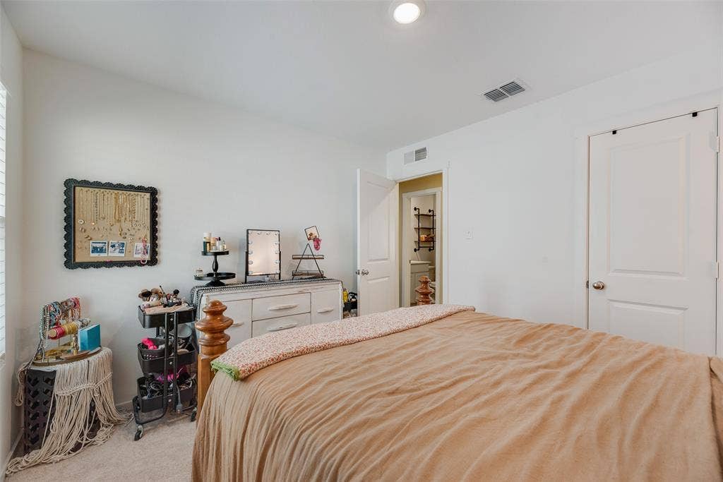 6742 Highlands Street, Princeton, TX 75407 Neutral wall tones, recessed lighting, and wall-to-wall carpeting featuring a solid-panel door and entry to a secondary space