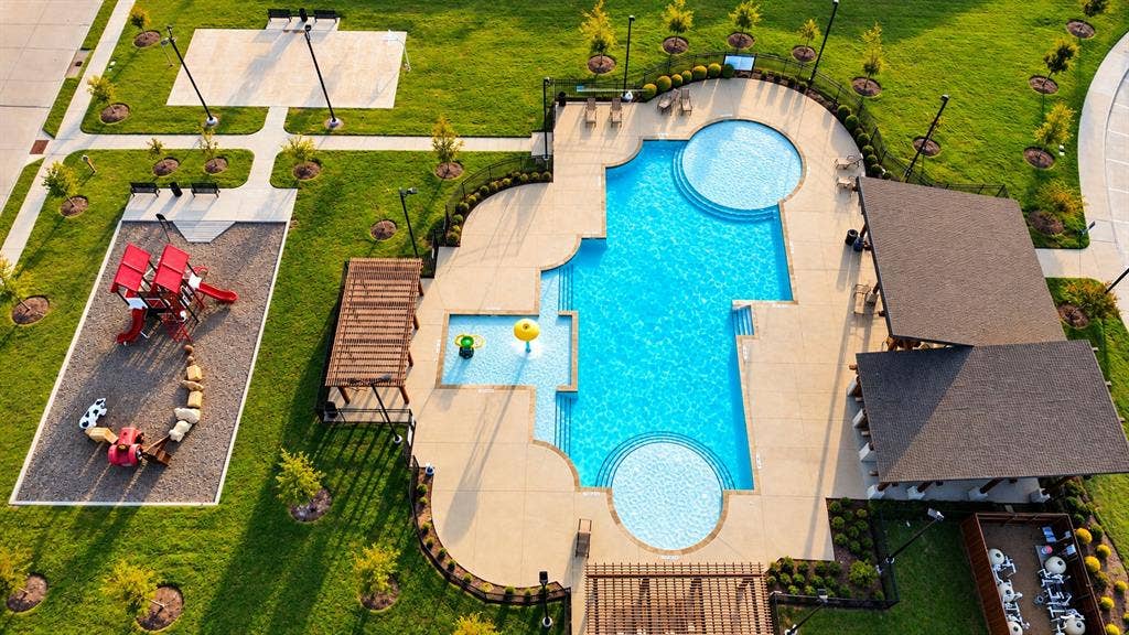 6742 Highlands Street, Princeton, TX 75407 Recreational complex featuring an inground swimming pool, a splash pad with water features, a shaded pergola, a structured playground area, and a covered pavilion