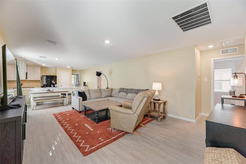 6742 Highlands Street, Princeton, TX 75407 Open-concept interior featuring wood-finish flooring and recessed lighting throughout
