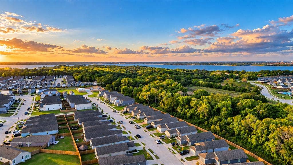 6742 Highlands Street, Princeton, TX 75407 Aerial perspective featuring residential lots, dense tree coverage, and a prominent water shoreline