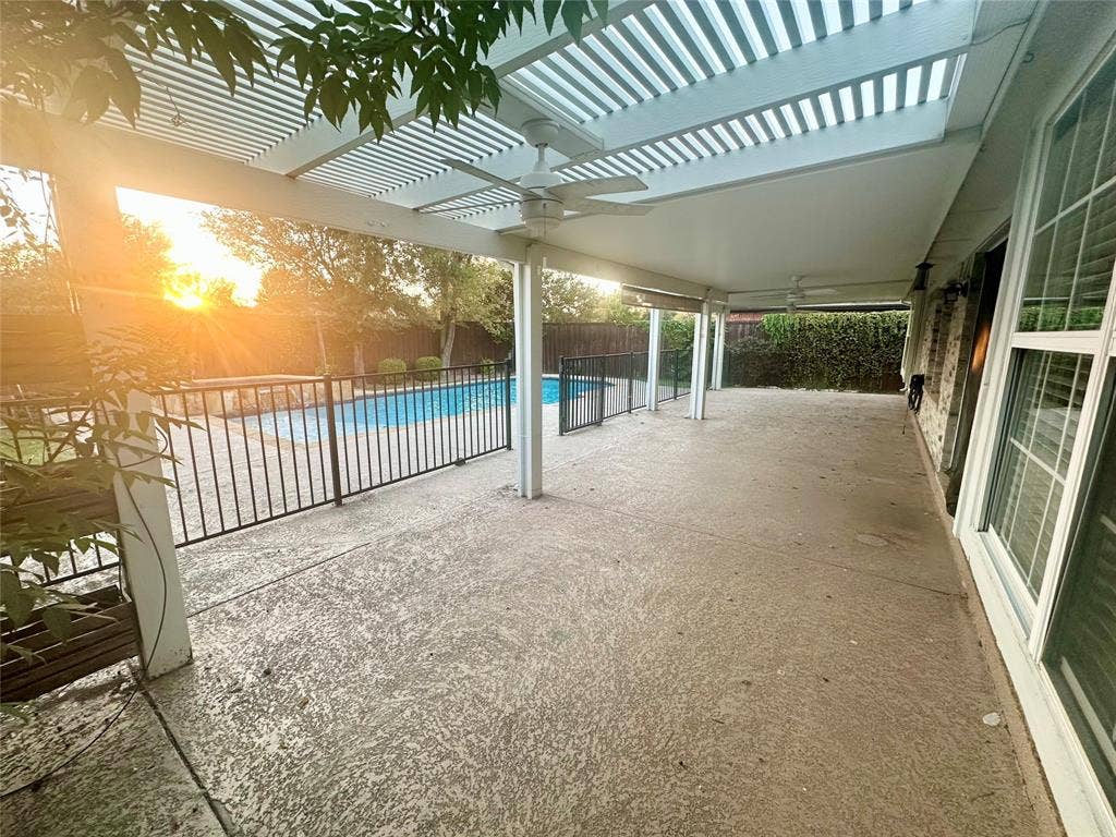 4327 Chasemoor Place, Frisco, TX 75035 Covered concrete patio featuring a louvered pergola, ceiling fans, and a perimeter metal fence enclosing an in-ground pool