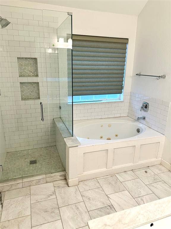 4327 Chasemoor Place, Frisco, TX 75035 Walk-in shower with floor-to-ceiling subway tile, dual built-in wall niches, and a frameless glass enclosure, paired with a jetted soaking tub featuring custom white paneling and white tile surround