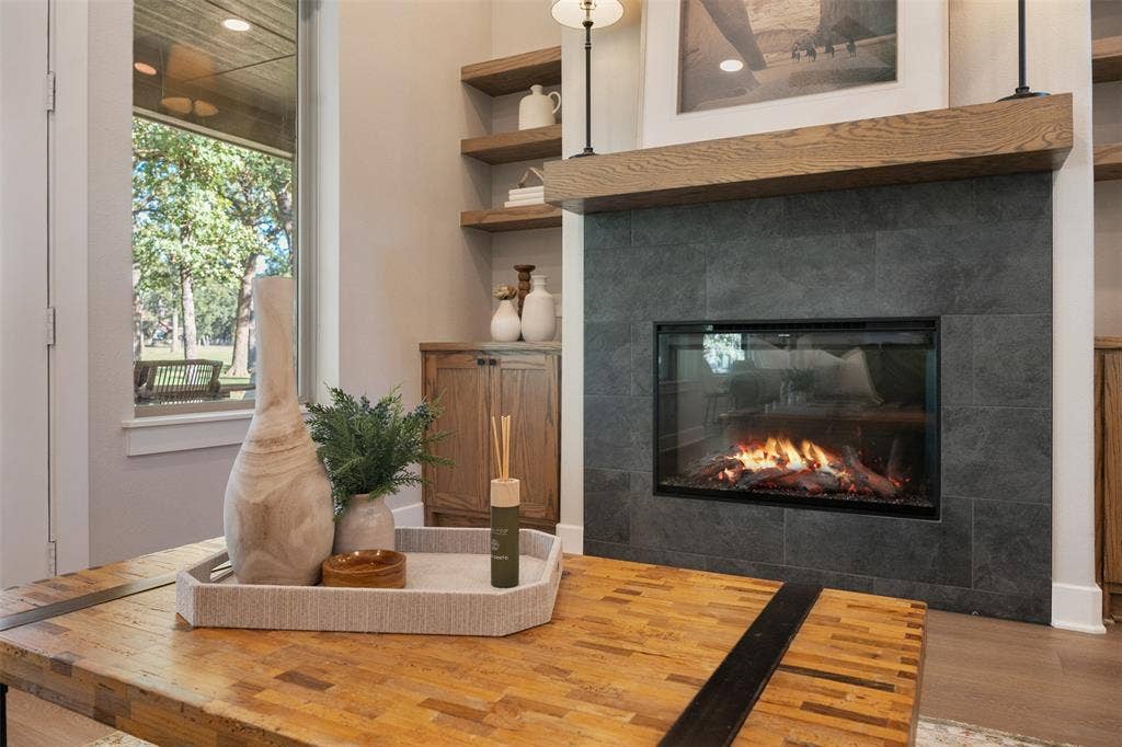 375 St. Andrews Drive, Mabank, TX 75156 Inviting fire place with custom shelving and storage