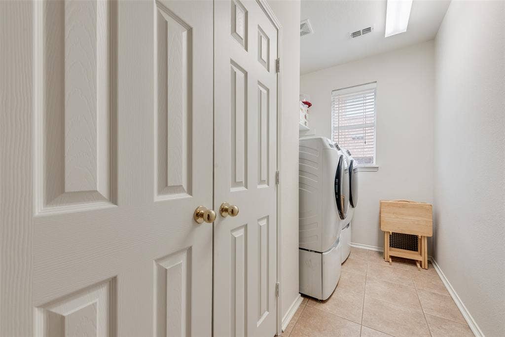 148 Oakbluff Drive, Murphy, TX 75094 Laundry room featuring ceramic tile flooring, neutral wall paint, and a built-in closet with raised-panel doors