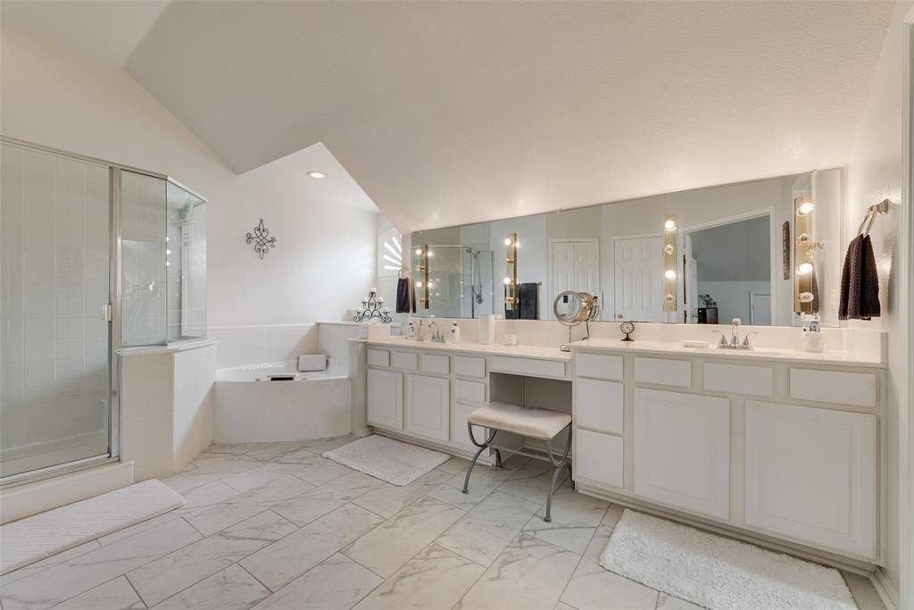 148 Oakbluff Drive, Murphy, TX 75094 Bathroom featuring tile flooring, a dual-sink vanity with built-in cabinetry, an integrated makeup vanity, a corner soaking tub, and a glass-enclosed shower
