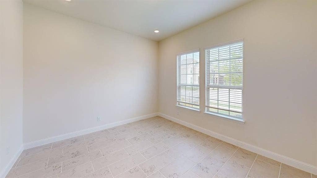 333 Elk Drive, Fate, TX 75189 Neutral-toned interior room featuring tile flooring, recessed ceiling lighting, and dual windows with fitted horizontal blinds