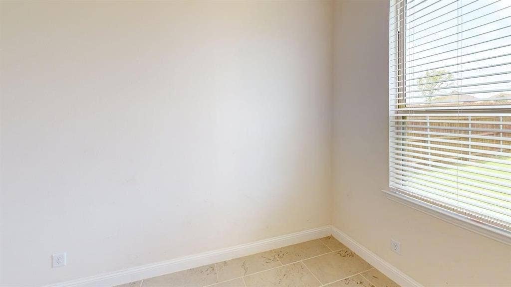 333 Elk Drive, Fate, TX 75189 Neutral-toned walls, tile flooring, and a window fitted with horizontal blinds