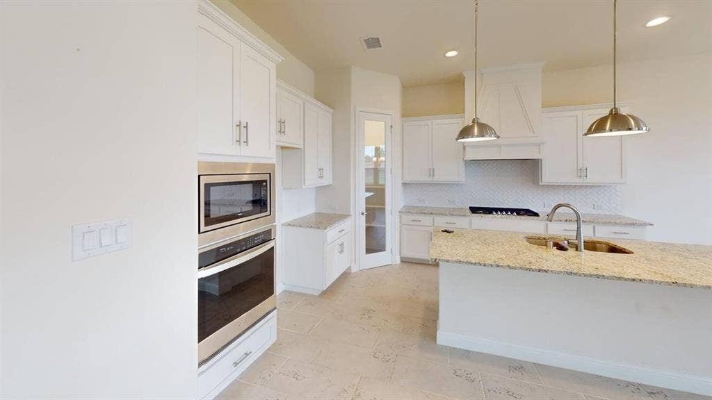333 Elk Drive, Fate, TX 75189 Kitchen featuring white cabinetry, stone-surface countertops, stainless steel wall-mounted oven and microwave, recessed lighting, and metal pendant light fixtures