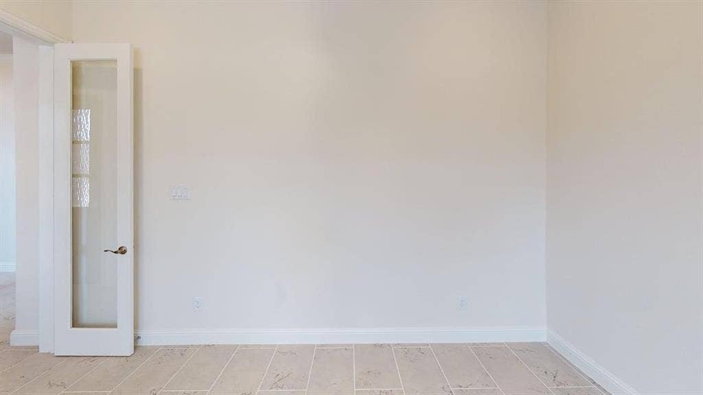 333 Elk Drive, Fate, TX 75189 Neutral wall finish paired with light-toned ceramic tile flooring and a white French door featuring decorative glass panes