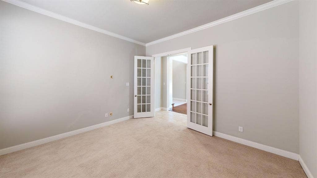 7005 Golf Club Drive, McKinney, TX 75070 Room featuring neutral wall paint, crown molding, plush wall-to-wall carpeting, and white glass-paned French doors