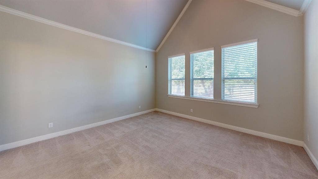 7005 Golf Club Drive, McKinney, TX 75070 Vaulted ceiling featuring crown molding, neutral wall color, and triple windows with horizontal blinds