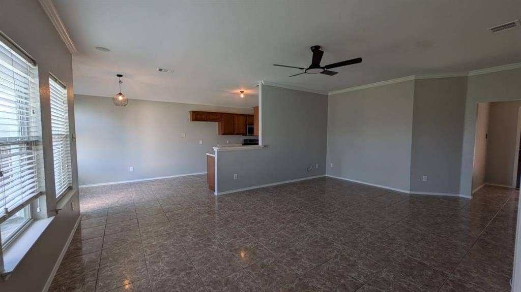 408 Oxford Loop Loop, Princeton, TX 75407 Open-concept interior featuring large-format tile flooring, recessed lighting, a modern ceiling fan, and crown molding