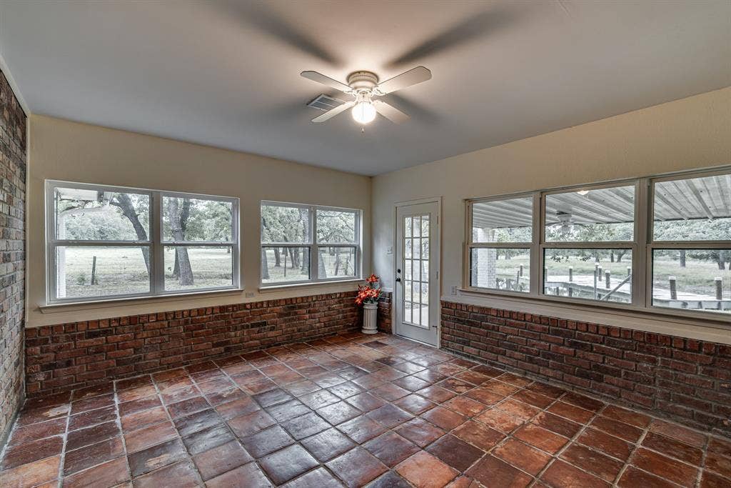 3754 Ft Graham Road, West, TX 76691 Enclosed & air conditioned sun room with view of dock & pond