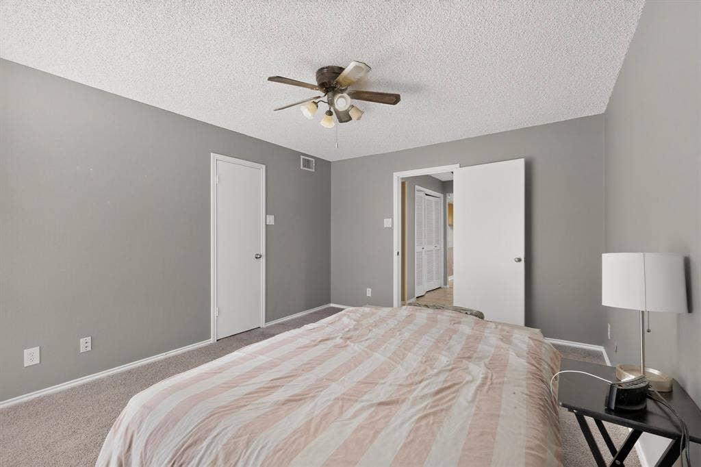 5750 Phoenix Drive, #6, Dallas, TX 75231 Carpeted flooring, neutral wall paint, ceiling fan light fixture, and white interior doors