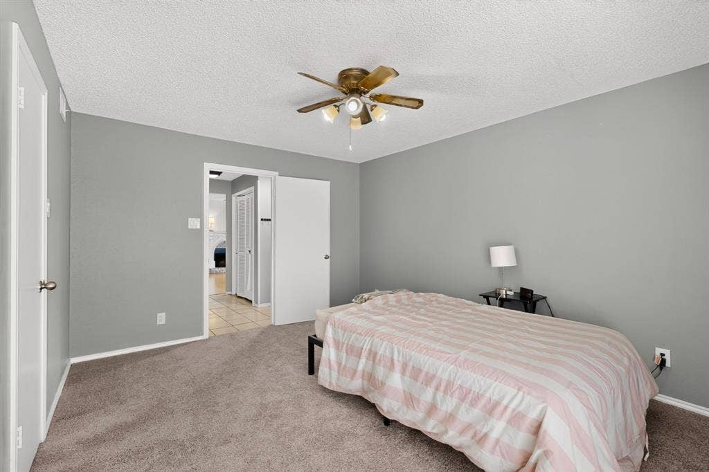 5750 Phoenix Drive, #6, Dallas, TX 75231 Wall-to-wall carpeting, ceiling fan with integrated lighting, and painted walls