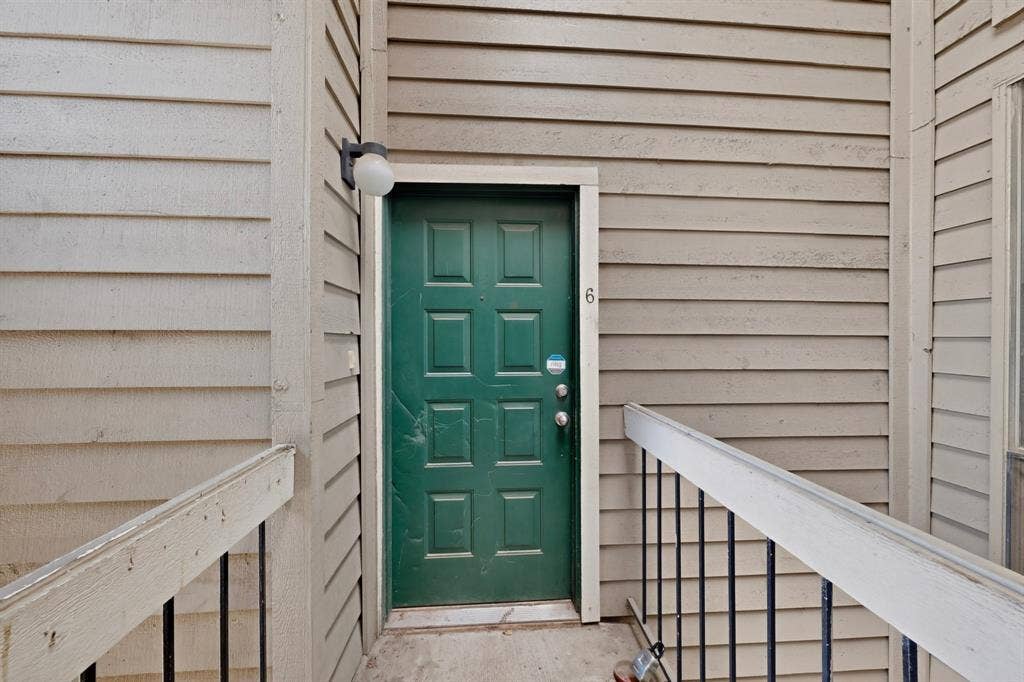 5750 Phoenix Drive, #6, Dallas, TX 75231 Six-panel entry door with a multi-paneled design and exterior light fixture