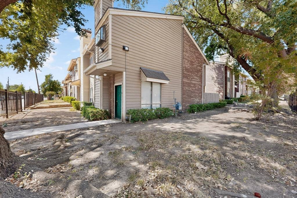 5750 Phoenix Drive, #6, Dallas, TX 75231 Siding exterior with brick accents and mature trees