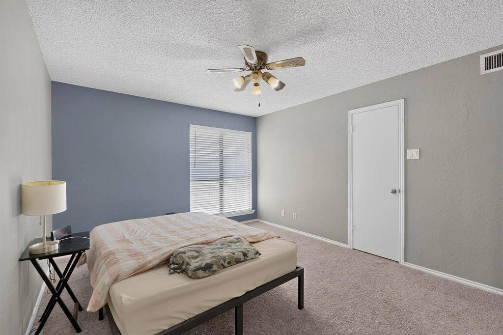 5750 Phoenix Drive, #6, Dallas, TX 75231 Carpeted room with a ceiling fan, window with horizontal blinds, and a white door