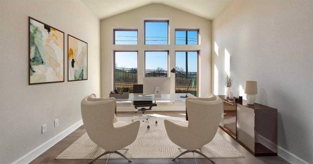 Vaulted ceilings, expansive multi-panel windows, and wood-finish flooring