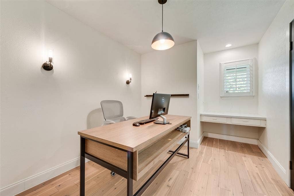 620 Cox Drive, Irving, TX 75062 Wood-finish flooring, built-in floating desk with dual drawers, dome pendant lighting, and dual wall-mounted sconces
