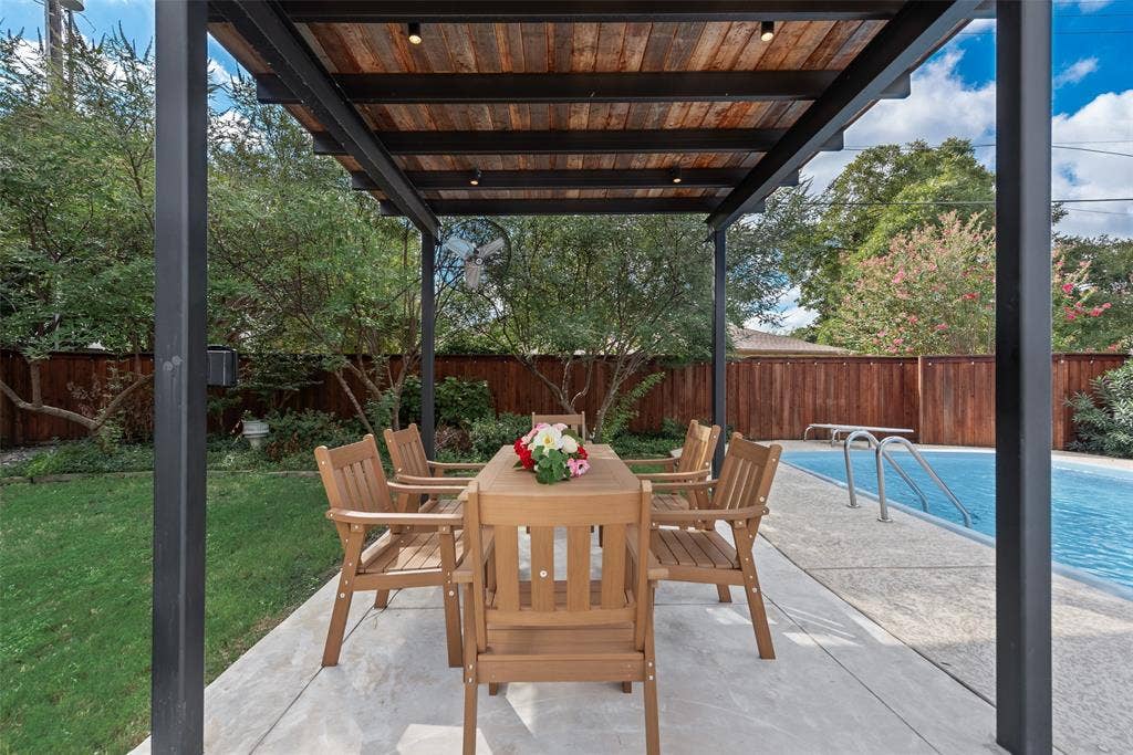 620 Cox Drive, Irving, TX 75062 Covered outdoor patio with a wood-plank ceiling, black metal structural framing, recessed lighting, concrete pool deck, and a swimming pool