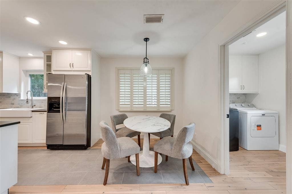 620 Cox Drive, Irving, TX 75062 Kitchen featuring white cabinetry, stainless steel refrigerator, apron-front sink, light-toned wood-finish flooring, and plantation shutters