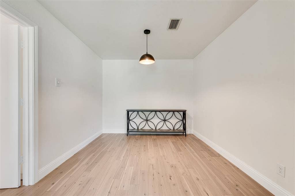 620 Cox Drive, Irving, TX 75062 Light-toned wood-finish flooring, neutral walls, and a contemporary semi-flush mount pendant light