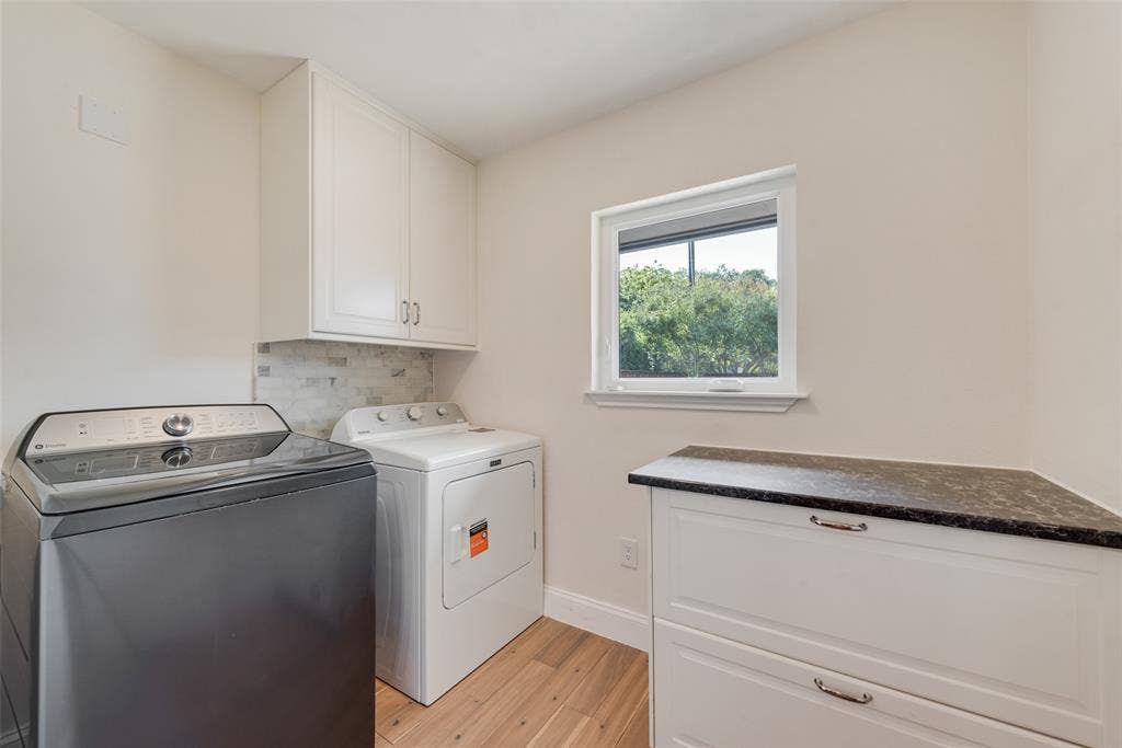 620 Cox Drive, Irving, TX 75062 Laundry area featuring white cabinetry, built-in lower storage with dark countertop, mosaic tile backsplash, and wood-finish flooring