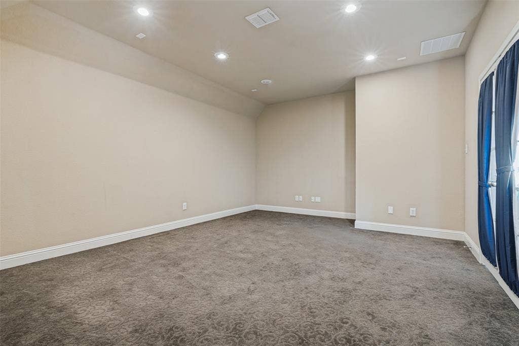 1380 Riverside Oaks Drive, Rockwall, TX 75087 Neutral-toned room featuring recessed ceiling lighting, wall-to-wall carpeting, and a glass-paneled door