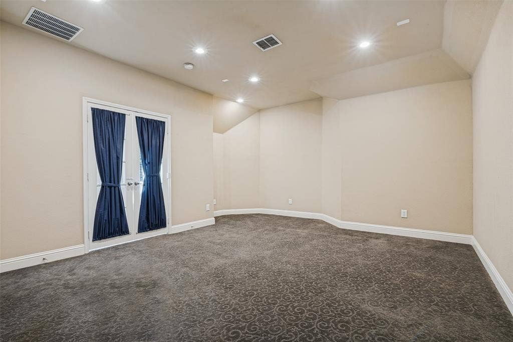 1380 Riverside Oaks Drive, Rockwall, TX 75087 Room featuring patterned carpeting, recessed ceiling lighting, and double glass-panel doors