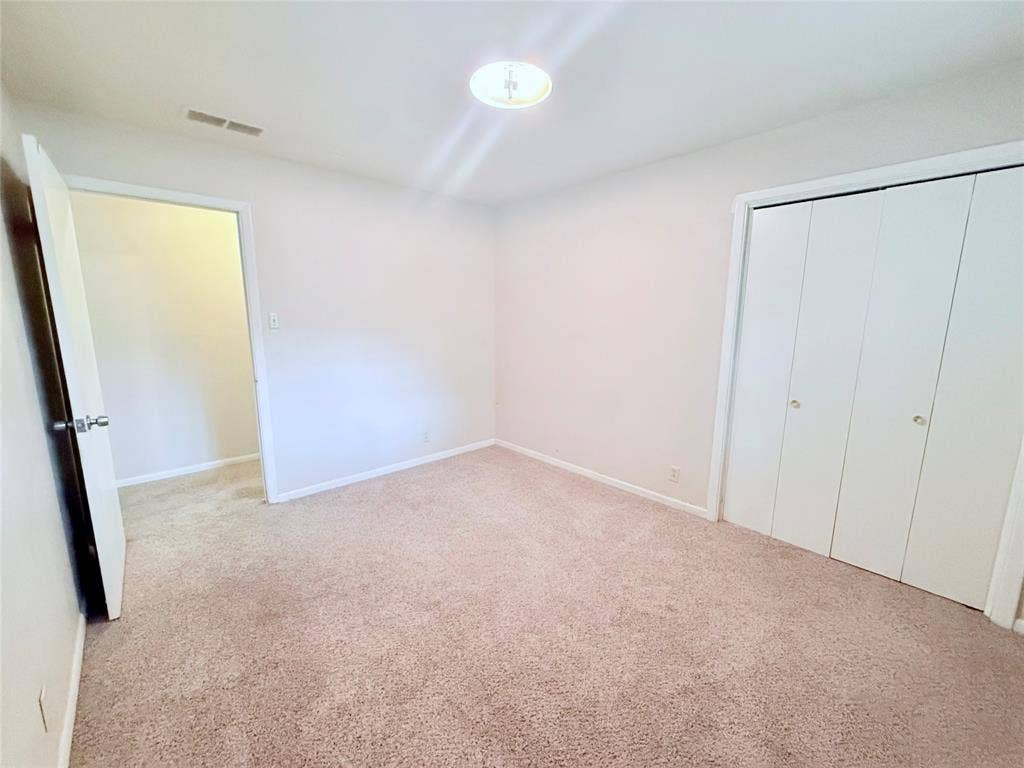1500 S Houston, Denison, TX 75020 Neutral wall-to-wall carpeting, flush-mount ceiling lighting, and double-door closet with polished hardware