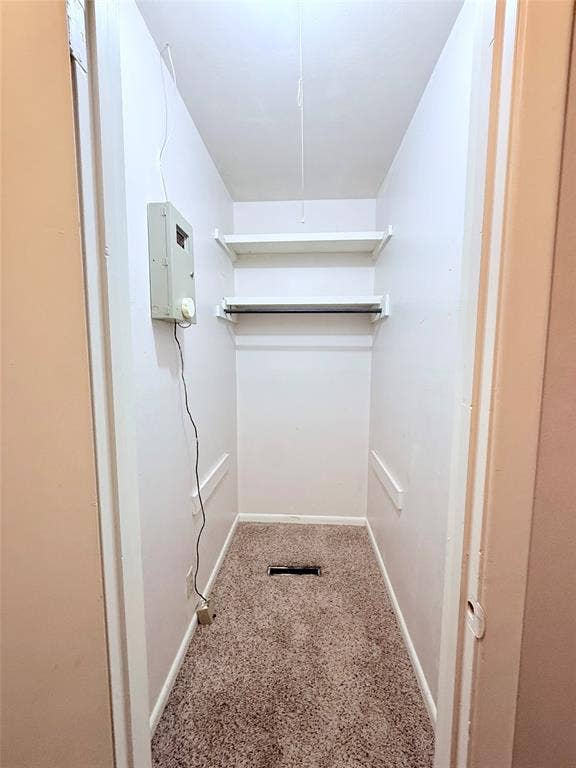 1500 S Houston, Denison, TX 75020 Storage space featuring carpeting and two white built-in wall shelves with a hanging rod