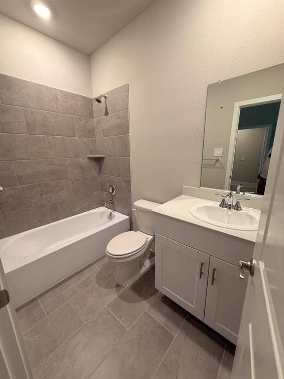 1313 Winters Way, Princeton, TX 75071 Bathroom featuring a vanity with an integrated basin, large format tile flooring, a shower-tub combination with horizontal wall tile surround, and a wall-mounted mirror