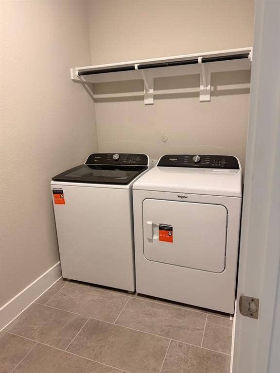 1313 Winters Way, Princeton, TX 75071 Laundry area featuring large-format ceramic tile flooring and a wall-mounted white shelving unit with an integrated hanging rod