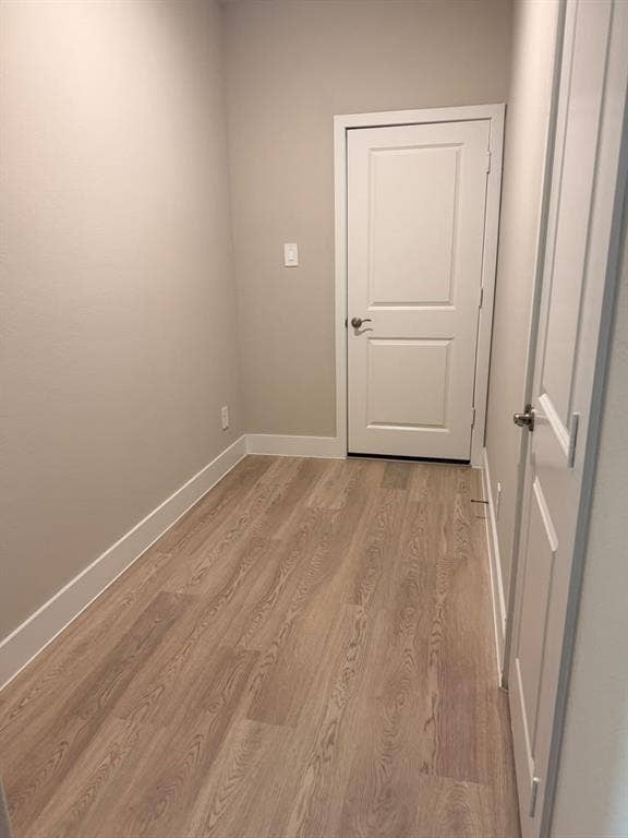 1313 Winters Way, Princeton, TX 75071 Neutral-toned interior space featuring wood-finish flooring and two-panel interior doors with satin nickel hardware