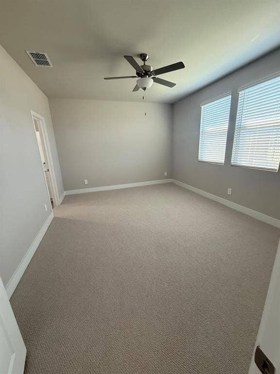 1313 Winters Way, Princeton, TX 75071 Neutral-toned carpeted room featuring wall-to-wall carpeting, a multi-blade ceiling fan with a center light fixture, and dual windows with horizontal blinds