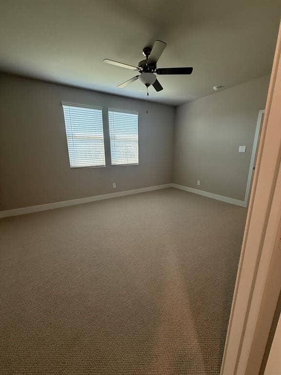 1313 Winters Way, Princeton, TX 75071 Neutral-toned interior space featuring wall-to-wall carpeting, dual windows with fitted blinds, and a ceiling-mounted fan with integrated lighting