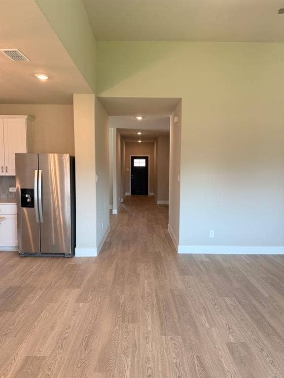 1313 Winters Way, Princeton, TX 75071 Open-concept kitchen area featuring wood-finish flooring, recessed lighting, and stainless steel refrigerator