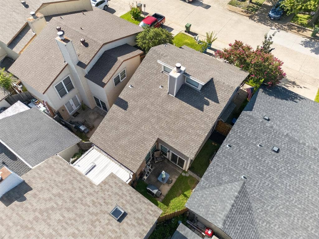 2851 Ursa Circle, Garland, TX 75044 Aerial perspective of a suburban neighborhood featuring residential housing, mature trees, open green space, and paved road infrastructure