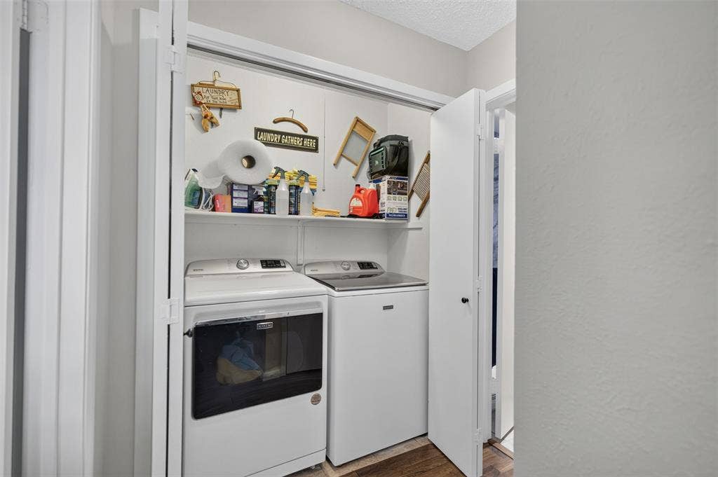 2851 Ursa Circle, Garland, TX 75044 Laundry closet featuring a built-in overhead shelf and dual bi-fold doors