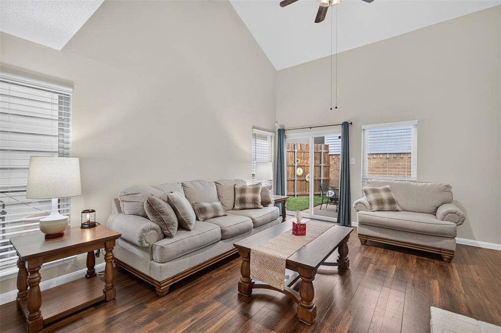2851 Ursa Circle, Garland, TX 75044 Vaulted ceilings, wood-finish flooring, and white-painted brick fireplace with a wood mantel