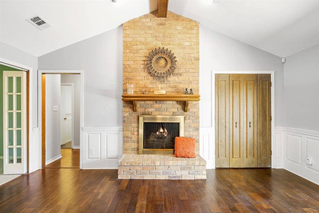 2510 Buttercup Drive, Richardson, TX 75082 The floor to ceiling brick fireplace is a focal point in the living room adding to the warming environment.