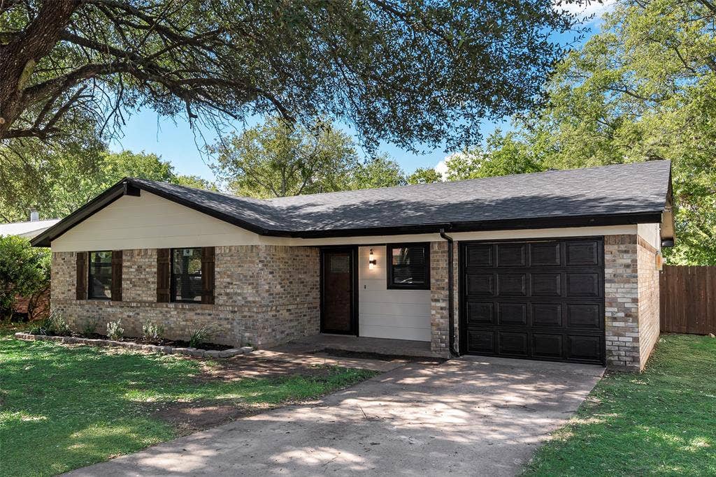 1238 Neptune Drive, Cedar Hill, TX 75104 Single-story brick exterior featuring a multi-textured facade, a covered entryway, an attached single-car garage with a paneled door, and dark-toned shutter accents