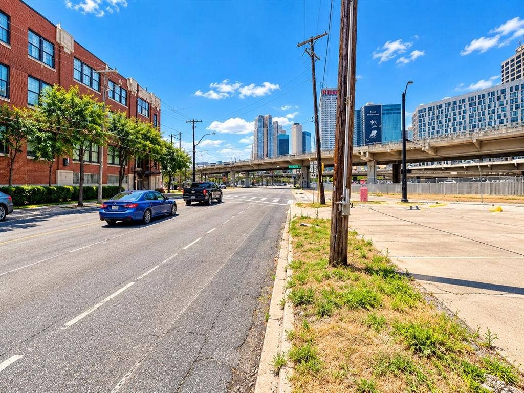 2502 Live Oak Street, #110, Dallas, TX 75204 Multi-story brick exterior building featuring a grid of rectangular windows