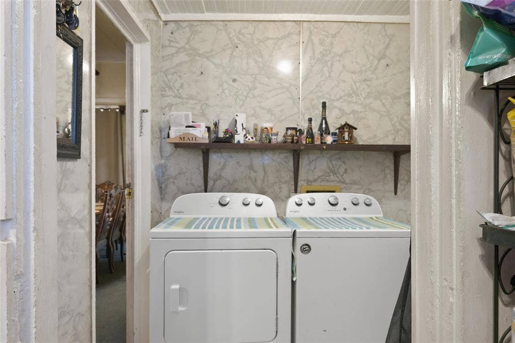 2309 Jones Street, Greenville, TX 75401 Laundry area featuring wall-mounted shelving and stone-patterned wall surfacing