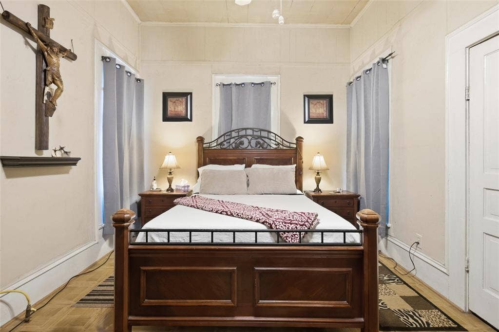 2309 Jones Street, Greenville, TX 75401 Room featuring wood-finish flooring, paneled walls, a neutral ceiling, and white door trim