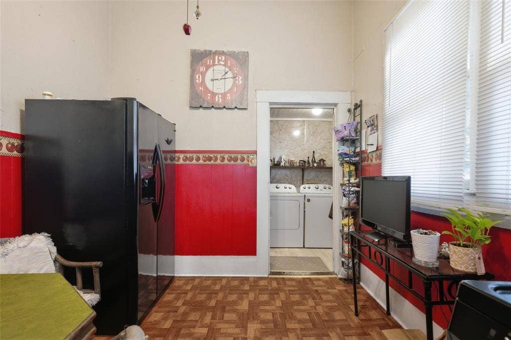 2309 Jones Street, Greenville, TX 75401 Kitchen area featuring wood-finish parquet flooring, two-toned wall detailing, and horizontal window blinds