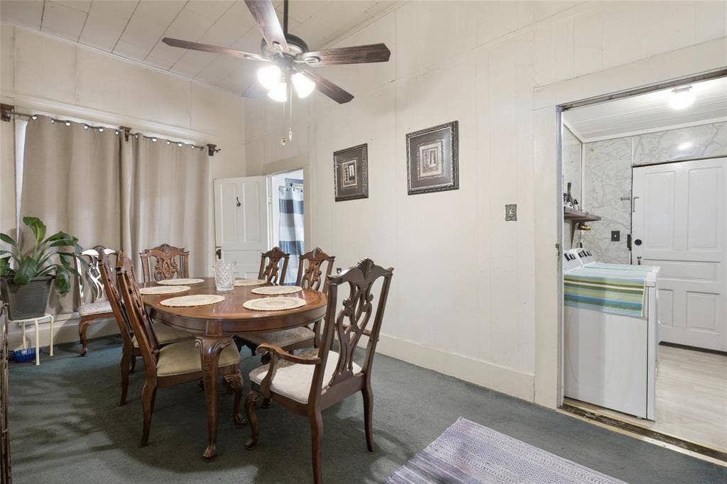 2309 Jones Street, Greenville, TX 75401 Plank-paneled walls and ceiling, ceiling fan with integrated lighting, and multi-panel solid doors