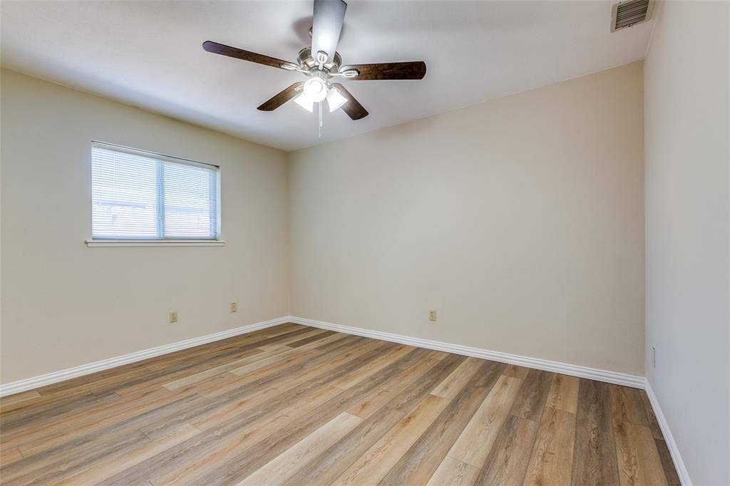 929 Arbor Downs Drive, Plano, TX 75023 Room featuring wood-finish flooring, neutral wall paint, and a ceiling-mounted fan with integrated lighting