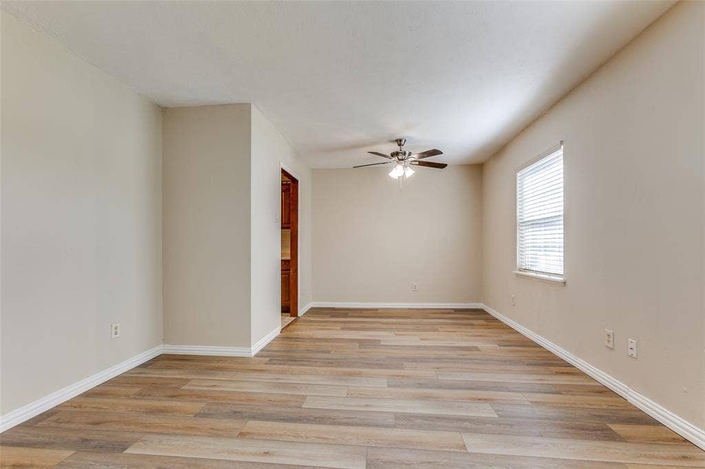 929 Arbor Downs Drive, Plano, TX 75023 Neutral interior featuring wood-finish flooring, a ceiling fan with integrated lighting, and a window with blinds